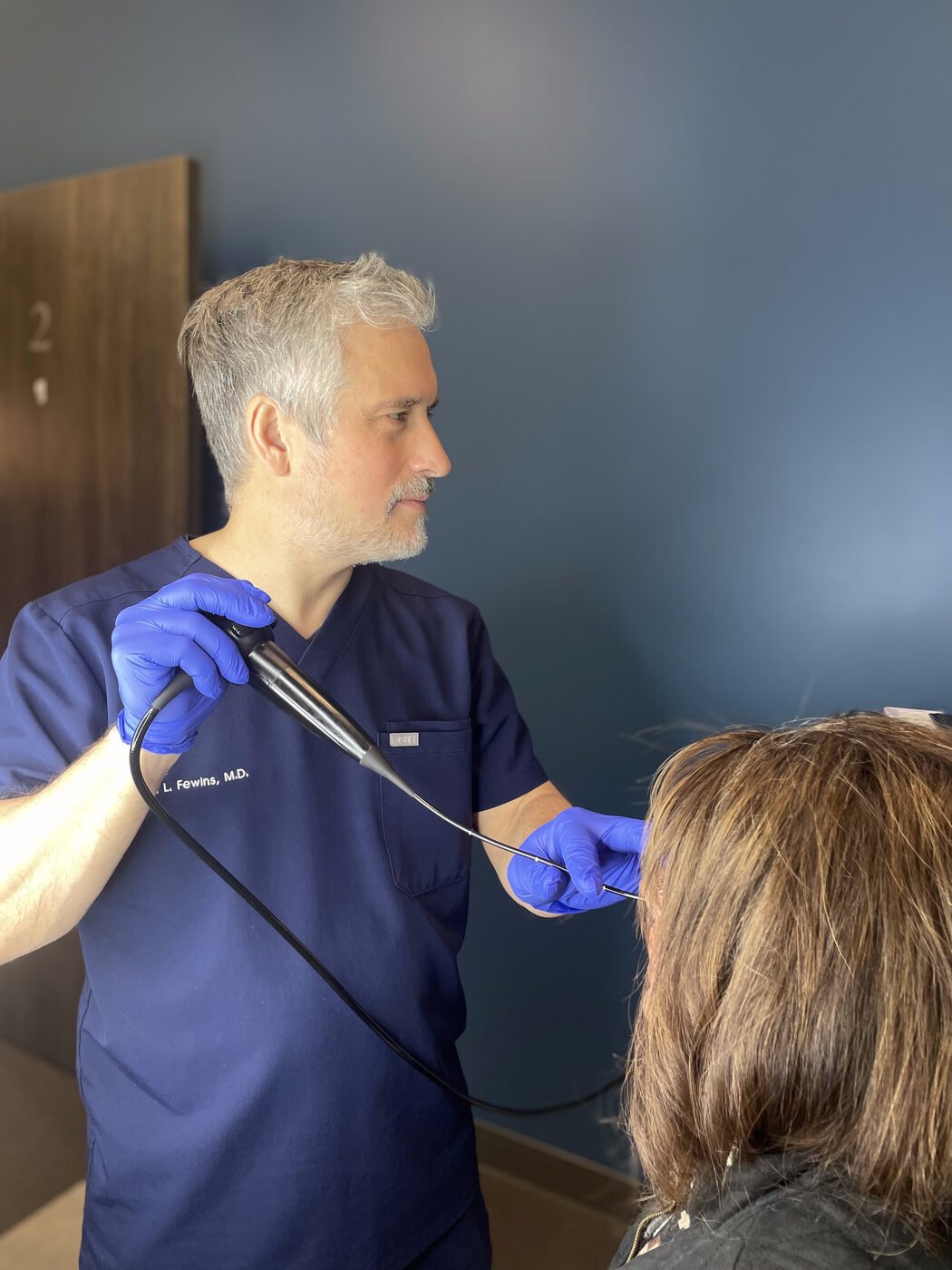 Dr. Fewins using nasal endoscopy during an office examination
