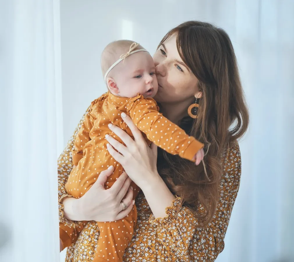 A mother holding her newborn baby